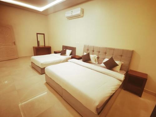 a hotel room with two beds and a couch at استراحه الصفا in Medina