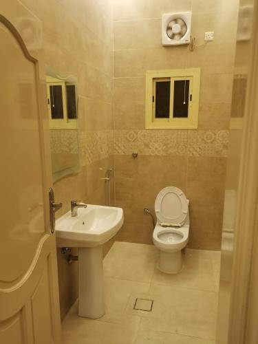 a bathroom with a toilet and a sink at استراحه الصفا in Medina