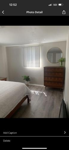 a bedroom with a bed and a dresser and a mirror at Boho Chic in New Port Richey