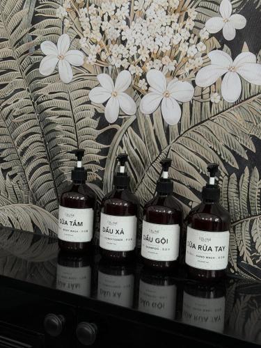 a group of four bottles of wine sitting on a shelf at Celine Privé - Dalat Hotel in Da Thien