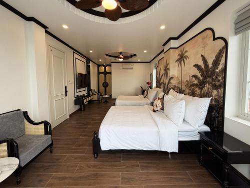 a bedroom with two beds and a couch and a ceiling at Celine Privé - Dalat Hotel in Da Thien