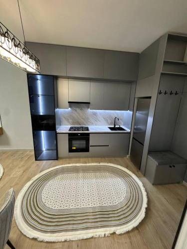 a kitchen with a large rug on the floor at Чарвак дарвозаси люкс апартамент, дом в горах с видом in Khŭjakent