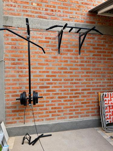 a recording studio with a brick wall at Casa cálida y confortable en Allen in Allen