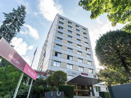 a tall building with a sign in front of it at Mercure Besancon Parc Micaud - Hotel & Bar in Besançon