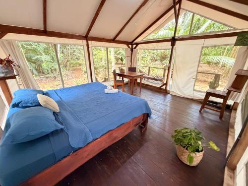 a bedroom with a bed in a tent at Sabalo Lodge Tours and Cabins in Sierpe