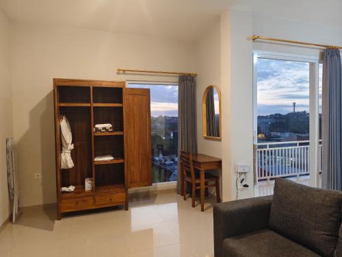 a living room with a couch and a window at Sarining 2BR Villa With Pool in Uluwatu