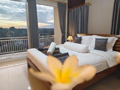 a hotel room with a bed and a large window at Sarining 2BR Villa With Pool in Uluwatu