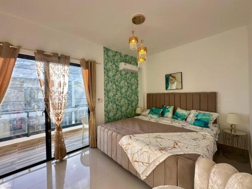 a bedroom with a bed and a large window at Villa Luminosa in Punta Cana