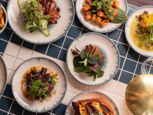 a group of plates of food on a table at Novotel Sydney Olympic Park in Sydney