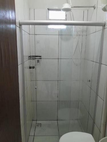 a bathroom with a shower with a toilet and a window at Rancho do Véio in Aquidauana