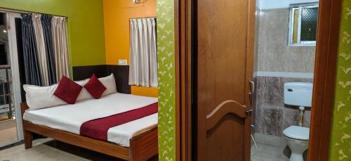a small bedroom with a bed and a toilet at Zeromiles Green Park in Digha