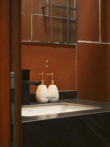 a bathroom sink with two bottles on a counter at căn 3 ngủ in Ấp Tân Long