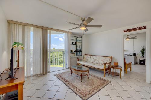 a living room with a couch and a tv at Hilo Lagoon Centre - 4BR Condos - Sleeps 12 in Hilo