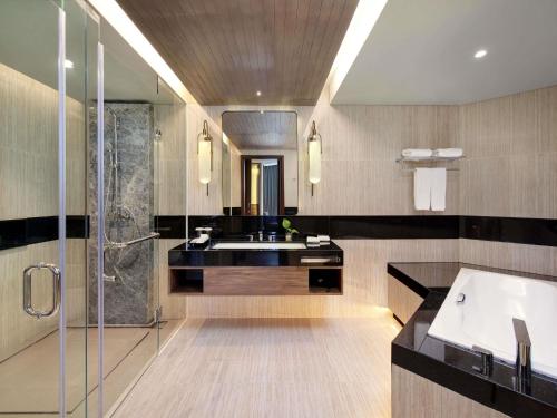 a bathroom with a sink and a shower at Mercure Pangkalan Bun in Pangkalan Bun