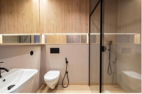 a bathroom with a shower and a toilet and a sink at K204 junto à Universidade in Guimarães