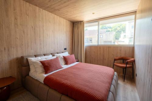 a bedroom with a large bed with a window at K204 junto à Universidade in Guimarães