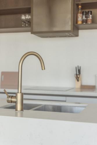a kitchen sink with a faucet on a counter at Park Avenue - UNO Melbourne in Melbourne