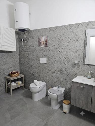 a bathroom with a toilet and a sink at Tina' S House in Cagliari