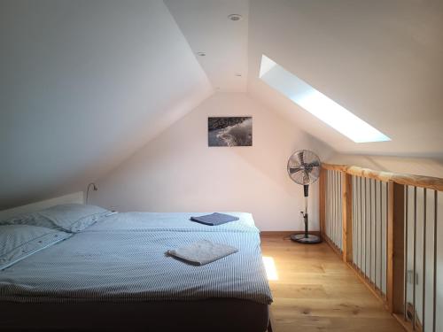 a bedroom with a bed in a attic at Guesthouse "Castello del Nucleo" in Intragna