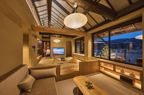 a living room with a couch and a large window at Wakasa Annex in Nara