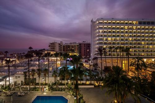 a hotel with a pool in front of a parking lot at SOL by Meliá Torremolinos Don Pablo in Torremolinos