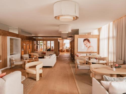 a restaurant with white furniture and tables and chairs at ME by Meliá Marbella in Marbella