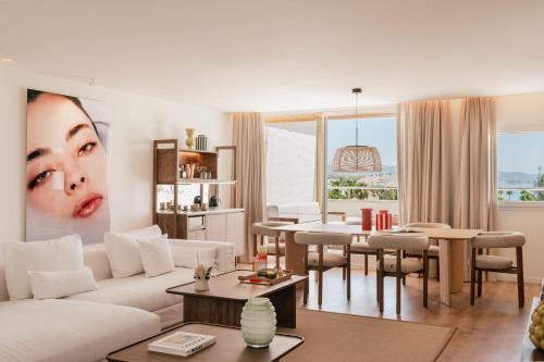 a living room with a white couch and a table at ME by Meliá Marbella in Marbella