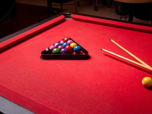 a felt pool table with cue balls and chopsticks at ibis Betim in Contagem