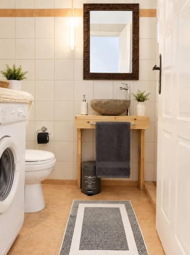 a bathroom with a sink and a toilet at Blue Topaz cottage Mini pool Spa in Nafplio