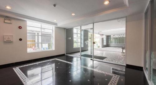 a large room with a glass door and a floor at Romance Hotel Srinakarin in Bangkok