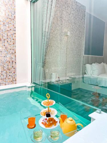 a room with a glass table with food on it at Skyline Resort in Ban Khlong Lat Bua Khao