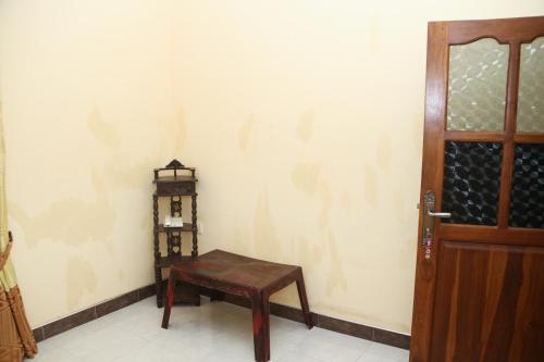 a room with a wooden table next to a door at veranda guest home in Mirissa