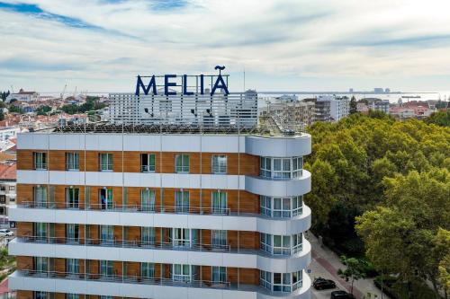 a building with a meena sign on top of it at Meliá Setúbal in Setúbal