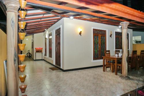 a living room with a table and a dining room at veranda guest home in Mirissa