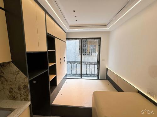 a room with a balcony with a bed and a window at Sunshine Housse with Balcony in Centre in Ho Chi Minh City