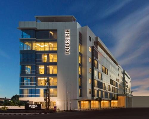 a large building with a sign on the side of it at INNSiDE by Meliá Yogyakarta in Yogyakarta