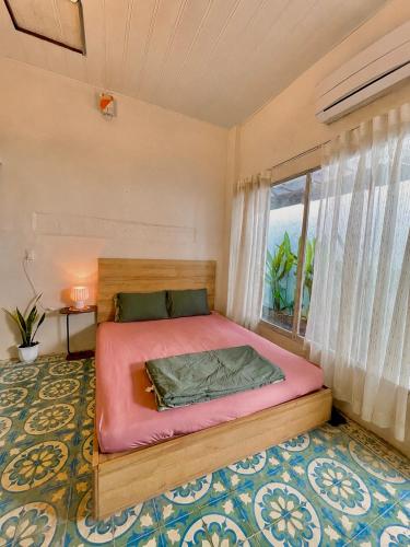 a bedroom with a bed and a large window at Brother House in Nha Trang