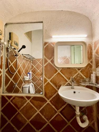 a bathroom with a sink and a mirror at Brother House in Nha Trang