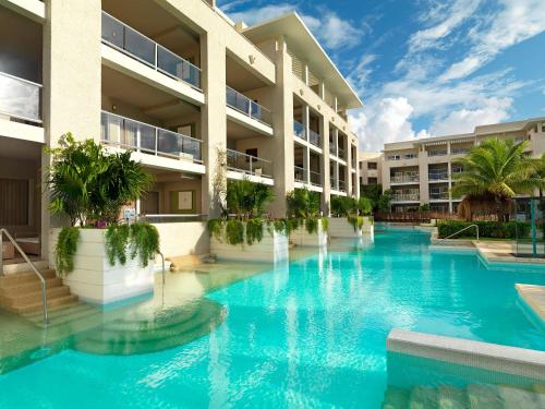 a swimming pool in front of a building at Paradisus by Meliá Playa del Carmen - Riviera Maya - All Inclusive in Playa del Carmen