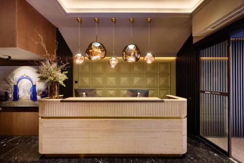 a lobby with a reception counter with lights at MiM Andorra member of Meliá Collection in Escaldes-Engordany