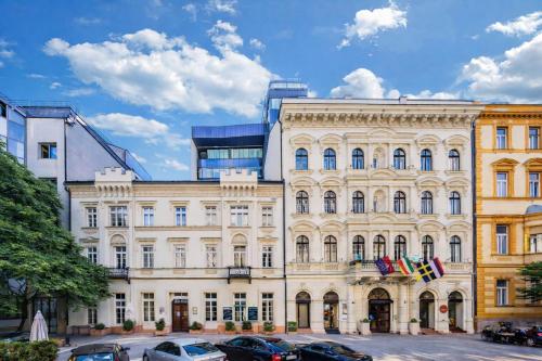a large building with cars parked in front of it at Hotel President Budapest, Affiliated by Meliá in Budapest