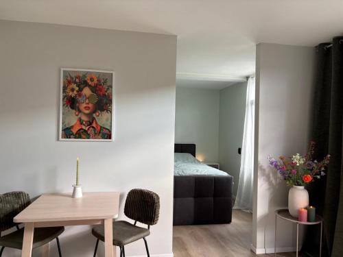 a room with a bed and a table and a room with a bedroom at Boterbloem Bed en Brood in Hardenberg