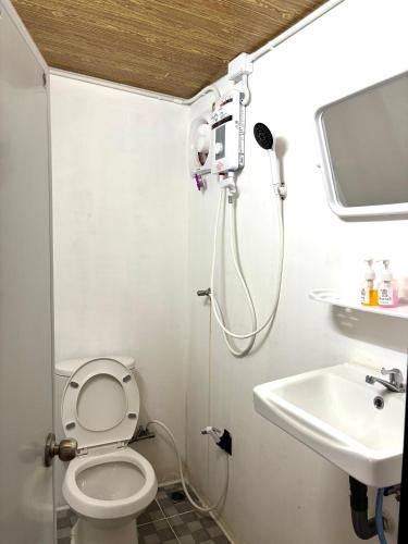 a small bathroom with a toilet and a sink at Chalok Garden bungalow in Ko Tao