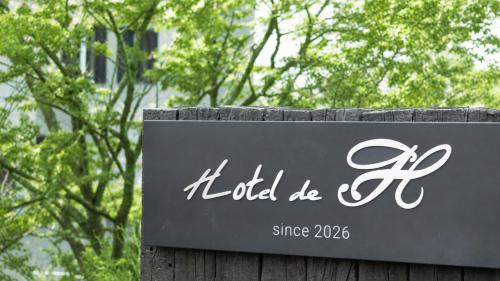 a sign for the hotel be at ホテルドゥアッシュ in Kushiro