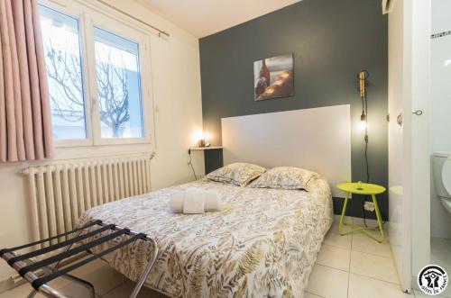 a small bedroom with a bed and a window at Maison venitia t2 in Aussonne