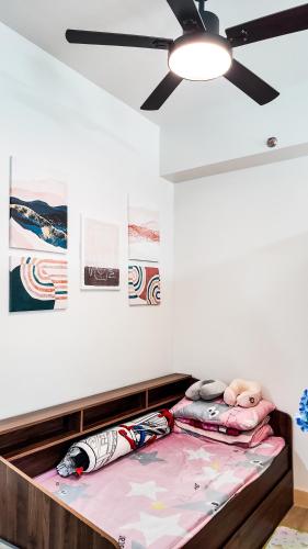 a bed in a room with a ceiling fan at The Nook at Park in Ibaba