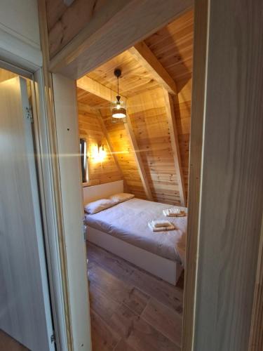 a bedroom with a bed in a wooden cabin at Max view Chalet Žabljak in Žabljak