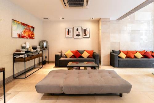 a living room with two couches and a table at Nicecy Ben Thanh Hotel in Ho Chi Minh City