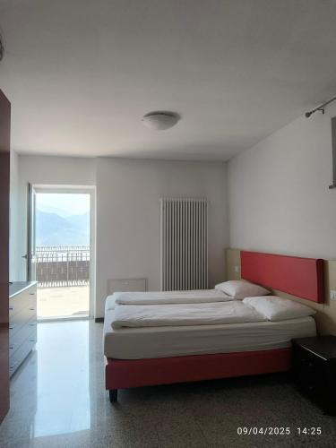 a bedroom with a large bed and a large window at Casa Lampone in Trento