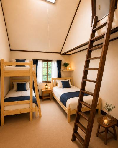 a bedroom with two bunk beds and a ladder at ペンションハートウォーマー in Myoko